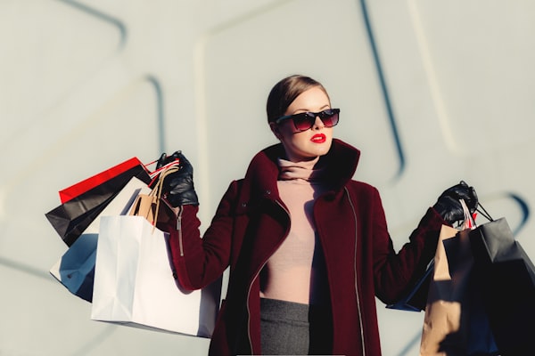 Hand holding colorful shopping bags